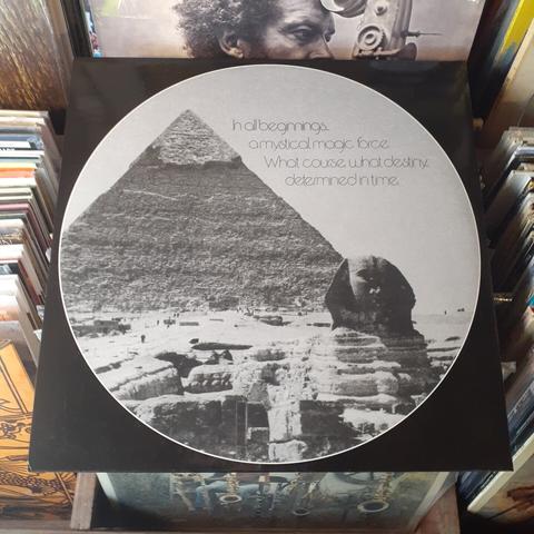 Back album cover shows a black and white photograph a pyramid and the sphinx in Egypt, with the words "In all beginnings, a mystical, magic force.  What course, what destiny,,, determined in time."
