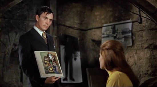 A man showing art collection to a captive woman.