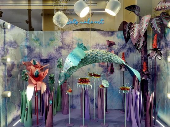 A very peculiar display of exaggerated fish and other ocean going items in a shop front window.