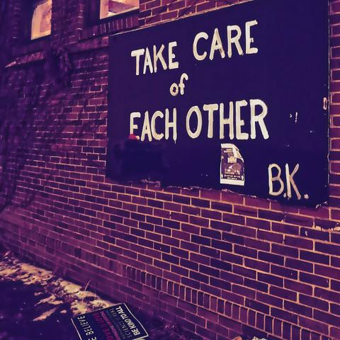 A street art sign that reads "TAKE CARE OF EACH OTHER." -B.K.