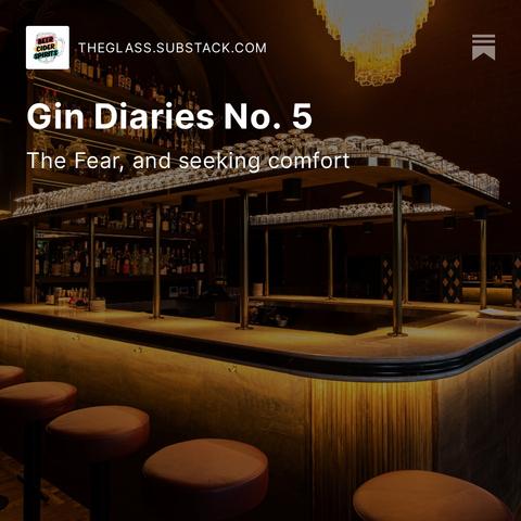 A picture of an empty bar with dramatic lighting. Barstools, glasses, bottles, all of that stuff. It looks like a nice place to drink — and it is.