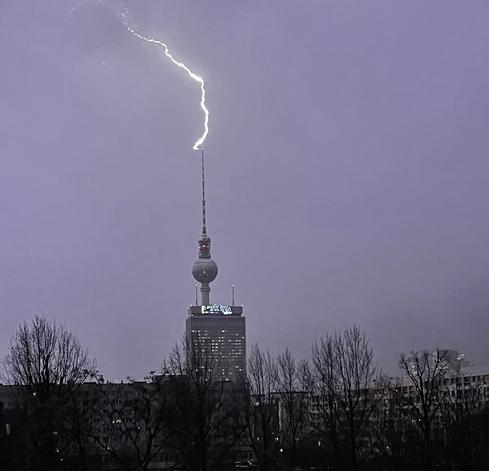 A lightning striking the top of the Berlin television tower near Alexanderplatz.
