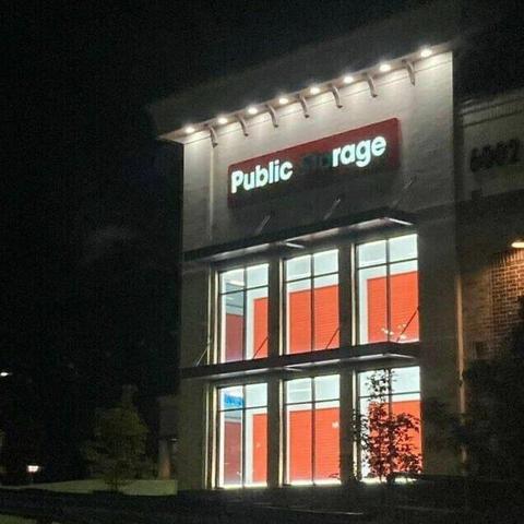 “Public Storage” sign on facility with the “Sto” letters unlit so the sign reads “Public rage”