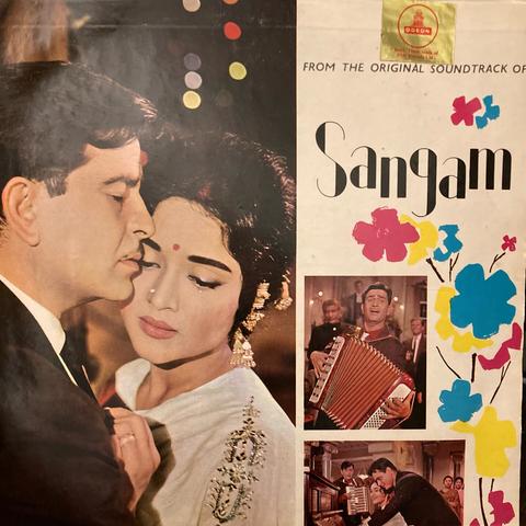 Cover of a 33rpm record album. The soundtrack to the Bollywood movie Sangam. The title is in the upper right quadrant in playful letters, and three stills fill most of the remaining space.