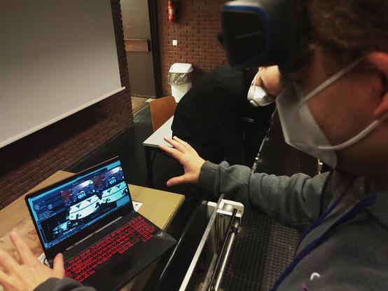 Me with a vr headset on my head in front of a laptop showing monado's debug gui with hand tracking visualization, as well as overte's vr view