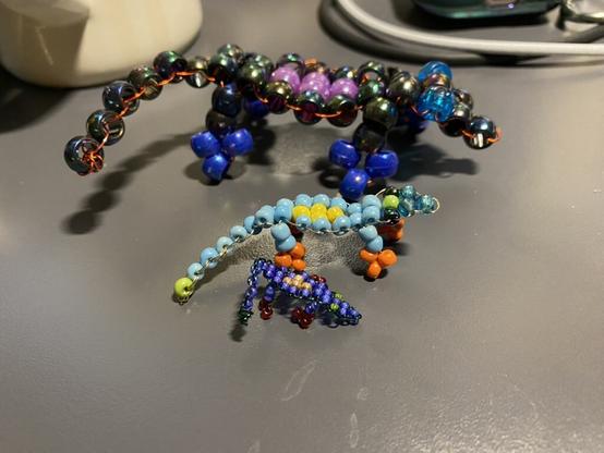 photo of 3 handcrafted/bend lizard wire sculptures made with beads. there are three lizard bead buddies, the largest is 13cm long, medium is 6.5 cm long, and the tinyest is 4cm long. the three face right.