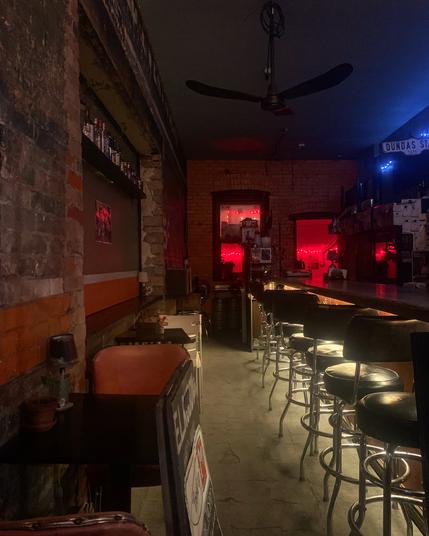 Looking through a window into an empty bar at 7am before dawn