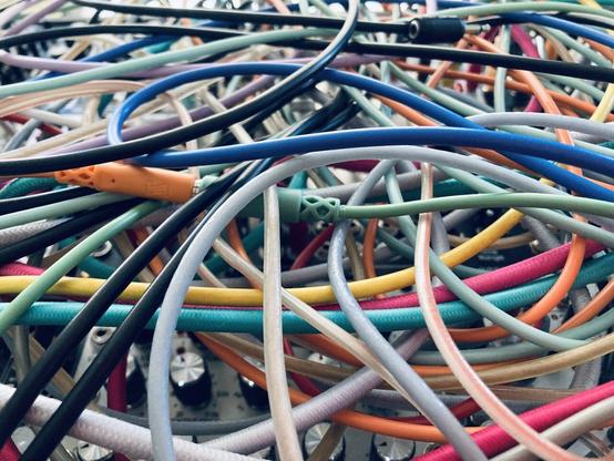 A modular synth covered in multi-colored cables