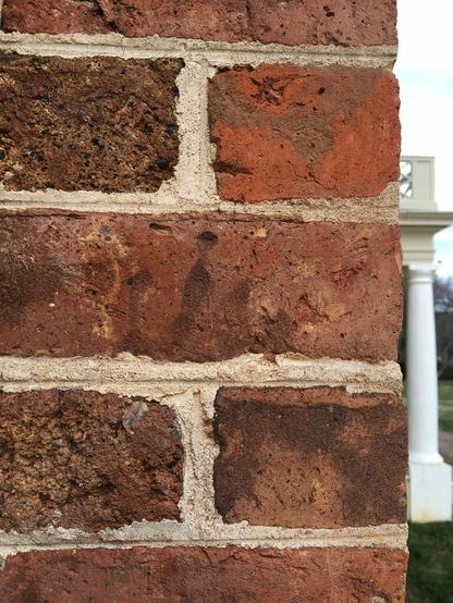 Photo of a section of one of the exterior walls at Montpelier. Imprinted on one of the bricks is a visible handprint, made from one of the people who the Madisons enslaved at Montpelier. Children and women were those most likely to have made the bricks at Montpelier and other plantations.