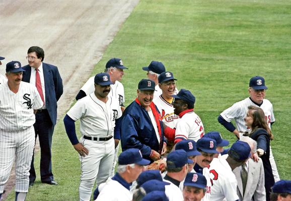 Hall of Fame member Ted Williams is the center of attention as he talks with former Cardinal Curt Flood. Flood's lawsuit against MLB paved the way for modern day free agency