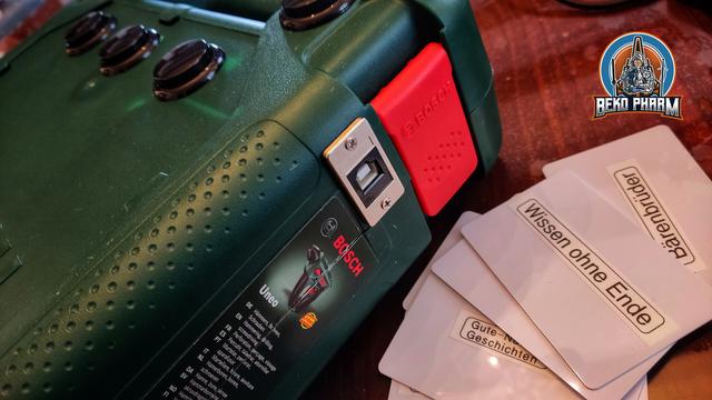 A former drill box with huge arcade buttons near it's handle and a very solid USB connector on the side. A bunch of RDIF cards with labels for various podcasts and stories for children are next to it.