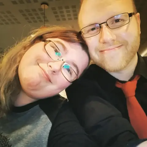 A selfie of Jenny and Fox, two white people in their prime: both wear glasses and look extremely attractive. Just FYI. They're a catch.