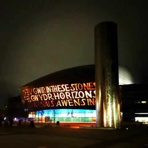 Wales Millennium Centre (...I think I have that right?) in Cardiff Bay at night, all lit up and pretty with big glowy letters on the facade.