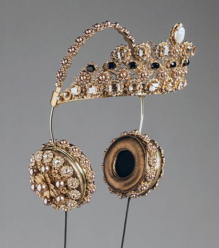 A 3/4 view studio photograph of the gold/leather/bejewelled Dolce & Gabbana headphones.