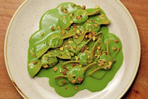 Plate of pasta, topped with pesto sauce