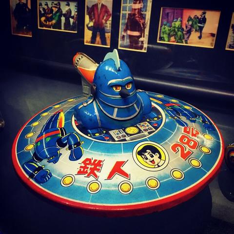 Toy metal flying saucer with "Gigantor" robot head and shoulders protruding from the top half.  Made in the 1960s.