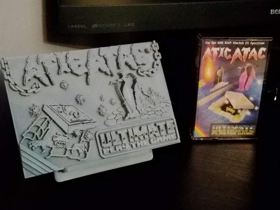 3d printed conversion of the atic atac loading screen from the ZX spectrum sitting alongside the original cassette tape case of the same game.
