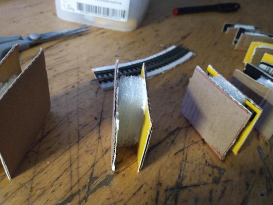 Photo shows the following:

close-up of one of the cardboard "pillars", with the small piece of styrfoam "sandwiched" inbetween.
