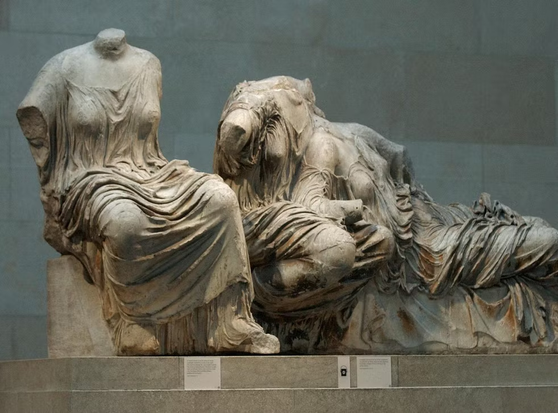 Seated and reclining marble female figures, from the Elgin marbles collection at the British Museum.