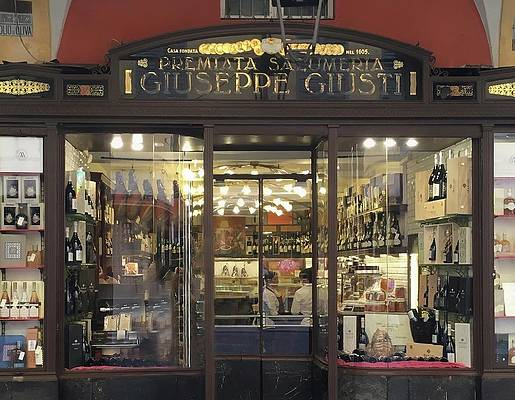 Guiseppe Guisti Premiata Salumeria. World known producer of fine balsamic vinegar since the 16th century, operating continuously out of the location in this image, by the same family.  Image of storefront.

In 1605, Guiseppe and Francesco Maria Guisti registered their "Salsicciai and Lardaroli" shop in the Duke of Modena's local business ledger. By 1700, the family was actively expanding its balsamic vinegar business. Then in 1861, in Florence at the Italian Exposition organized by the Italian Royal Family, Giusti was awarded a gold medal for its 90-year old balsamic. Between the 19th and 20th centuries, Giusti balsamic vinegar became recognized worldwide and was an unanimous success throughout Europe. Presented at various international exhibitions of the Belle Epoque, the most important of the Giusti vinegars; 30-year, 50-year and 100-year, has won numerous prestigious accolades, including 14 gold medals.