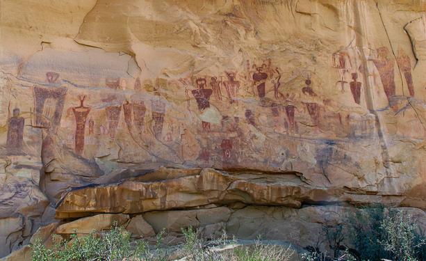 Uncropped view of the previous photo. Strange looking figures painted red on a rock wall in Utah. Over 1,000 years old.