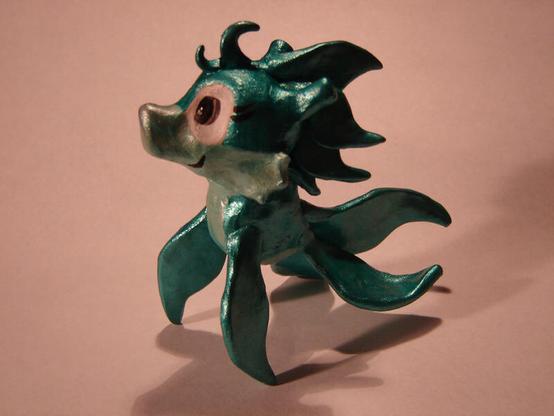 A figure made from Sculpey sculpting material and painted with metallic acrylics, depicting an original character done in a Sonic the Hedgehog style, named Leta the Sea Dragon.