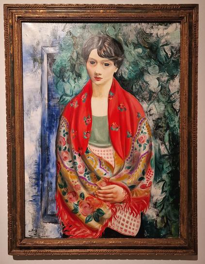 In the picture you can se a painting by Moïse Kisling with the title: "Femme au Châle Polonais" (in English: Woman with a Polish Scarf), oil on canvas, 1928.
.
Mojzesz Kisling (1891 - 1953) was a french-polisg painter. He studied in Krakow and moved to Paris in 1910. Kisling was known for his landscape paintings, as well as his masterful depictions of the female body, and his surrealist nudes and portraits were widely acclaimed. He had his first solo exhibition in 1919 at Galerie Druet and showed at Galerie Guillaume in 1924. In th 1920s, he distanced himself from cubism and took a more personal path in art. His studio was one of the main meeting places for the Montparnasse artists.

The largest collection of Kisling's works is located at the Musée Petit Palais in Geneva.