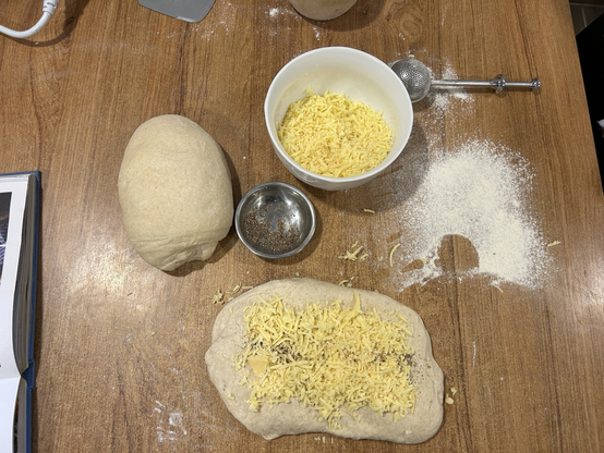 Closeup of the dough, just before I will start to fold the cheese and cardamom into it. In the shot: two pieces of dough, one already flattened and covered with the filling.