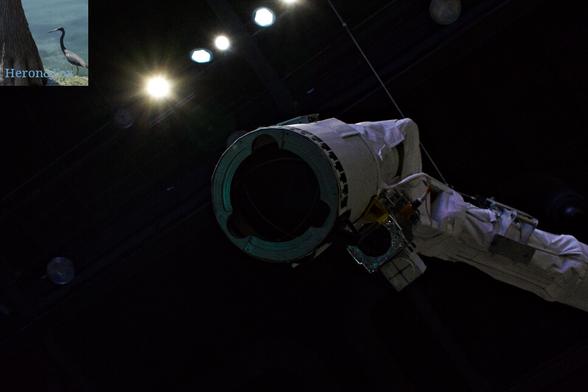 A photograph of the end effector of the Remote Shuttle Manipulator System or Canadarm.
The end effector is a white cylinder with brass blades that close and lock onto a special grapple fixture.