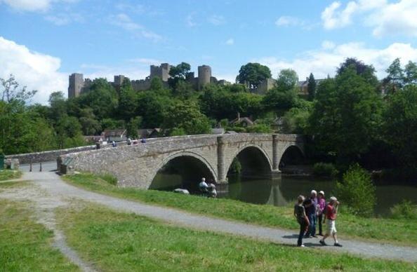 Bridge in Ludlow with the castle towering over the town in the background.