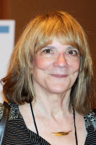 Elizabeth Loftus portrait photography. She is smiling with pursed lips.