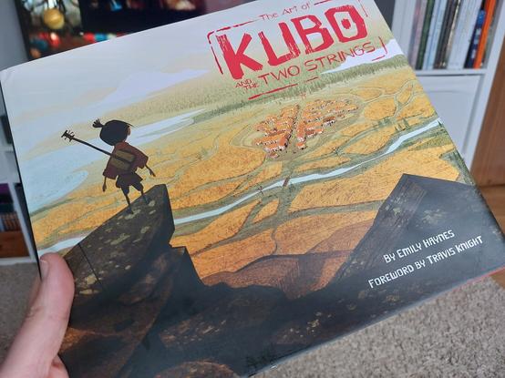 Photo of the latest alconcept art book I've added to my collection. The cover is a beautiful concept piece of Kubo on a mountain top overlooking a distant village.