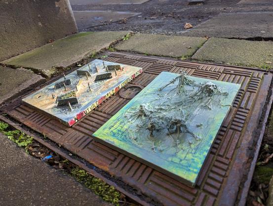 Two artworks on a drain cover