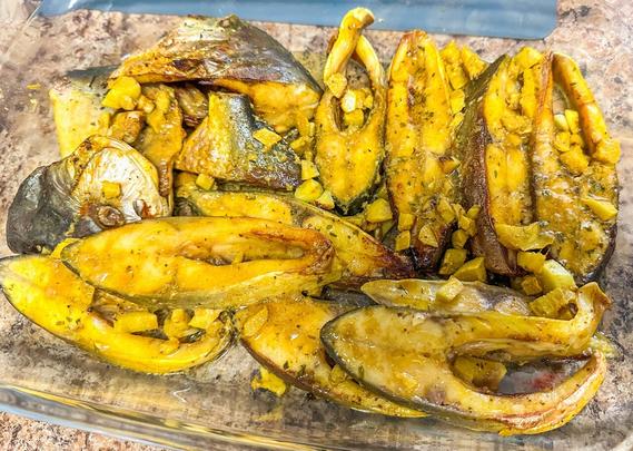 A baking dish with fried pieces of fish