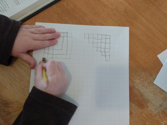 Luke has drawn a five-by-five square next to a "step-squad" arrangement of twenty-one, with twenty-one squares arranged in an upside-down step shape. He accidentally drew a six-by-six square which he is in the process of erasing.