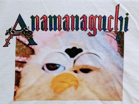 An extremely distressed-appearing Furby below the word "Anamanaguchi" in a pixelated Gothic font