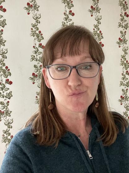 A photo of me with my new glasses, making a silly face.