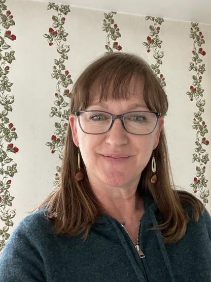 A photo of me and my new glasses that have gray frames.