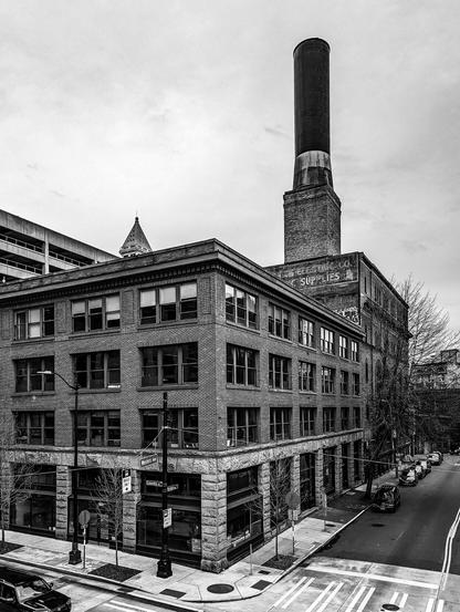 Journal Building - Western & Columbia, Seattle WA.  Owned by the Daily Journal of Commerce since its completion in 1914, the Journal Building is listed on the National Register of Historic Places and has been designated a contributing building to the Pioneer Square National Historic District. The Journal Building is an exceptionally well-preserved example of turn-of-the-twentieth-century commercial architecture. The building has a ground floor level with large display windows and rusticated stone cladding, and there are three floors of finely detailed brick above. The building’s original wood windows are still intact and in place, as is the original decorative metal cornice at the top of the façade.