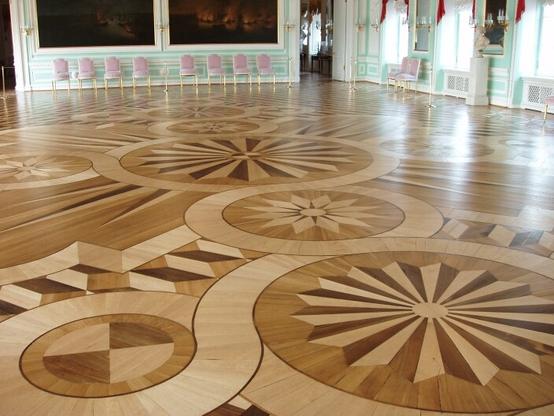 The intricate geometrical patterns of the highly-polished marquetry floor