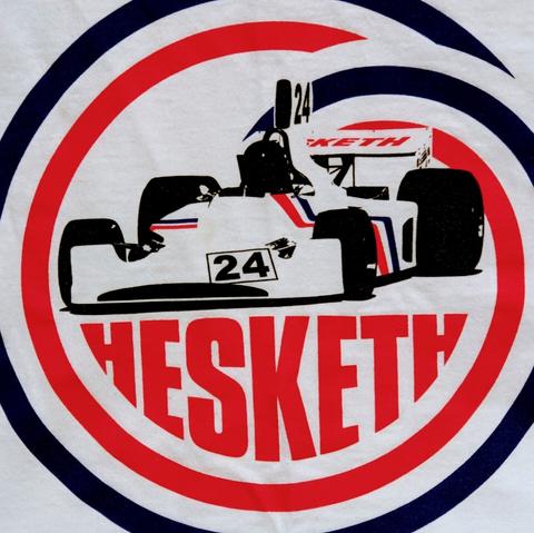 A t-shirt displaying James Hunt's № 24 Hesketh Formula 1 car, with the word "Hesketh" below it, in a red, white and blue swirl