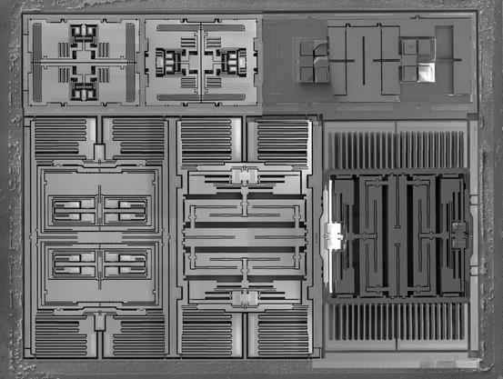 Electron microscope image of a MEMS accelerometer/gyroscope device by BreakingTaps.
the device consists of 6 rectangular subunits, each with microscopicly fine, symmetric layouts. Interlocking, cone like elements on both ends of the subunit act as tiny capacitive sensors to measure miniscule movements from the rest of the unit.