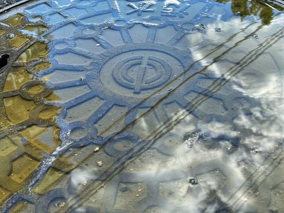 Reflection on water over a manhole