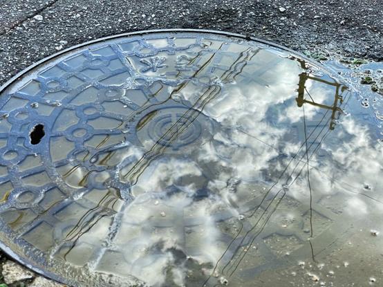 Reflection on water over a manhole