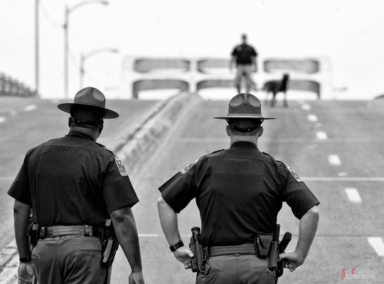 How far we have come where a black and white Alabama State Troopers stand side by side to make sure the Pettis bridge is safe for the crossers.
And yet, so far to go.