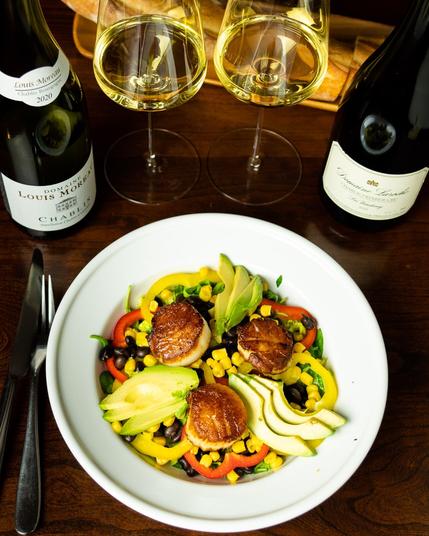 Photo of Louis Moreau Chablis and Domaine Laroche Chablis 1er Cru wines with seared scallops on a western style salad