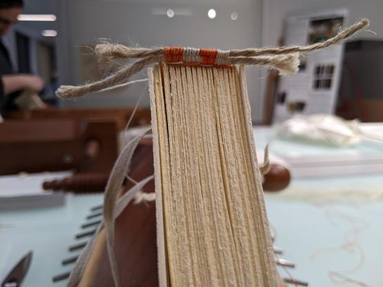 Textblock with partially sewn endband in two layers.