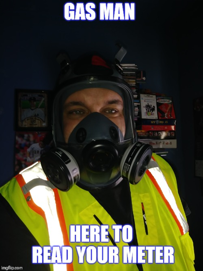 Male with safety vest helmet (no goggles) and particle canister mask caption "Gas Man"  "Here to read your meter"