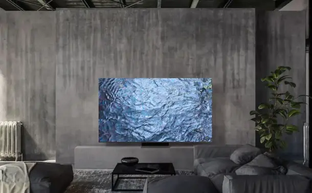 Stock image of a 75" 8K Samsung QN900C Neo-QLED TV sitting in a grey concrete living room.