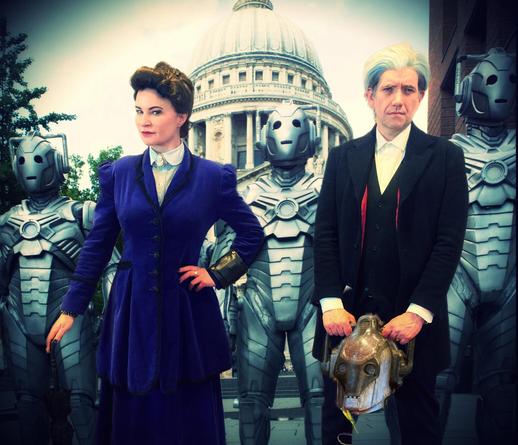 Two cosplayers, Joanne Alexander as Missy, and Peter Nolan as the Twelfth Doctor, in their Dark Water costumes, the Doctor holding a damaged Cyberhead prop repica, all composited into the army of Cybermen outside St Paul's from that episode.